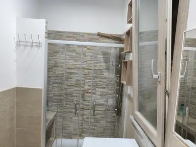 a bathroom with a shower with a glass door at Heidi's home in Villabate