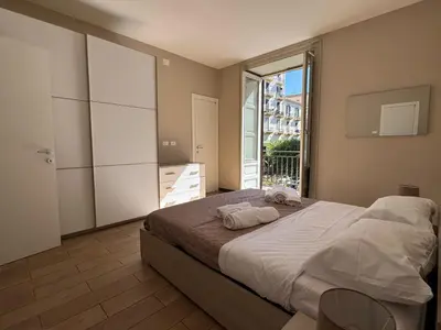 a bedroom with a large bed and a large window at ÀSicilia Home Holiday in Palermo