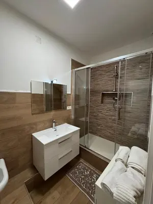a bathroom with a white sink and a shower at ÀSicilia Home Holiday in Palermo