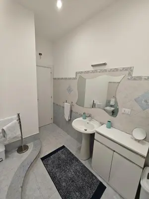 a bathroom with a sink and a mirror at Kennedy 100 in Capaci