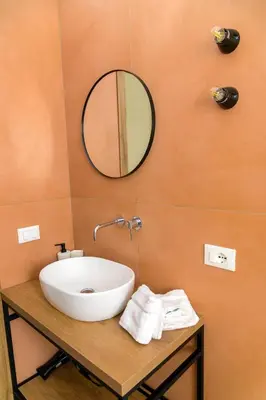 a bathroom with a toilet and a sink at Curò in Cinisi