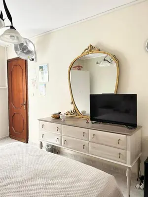 a bedroom with a dresser with a mirror and a tv at La Casa del Sole in Corleone