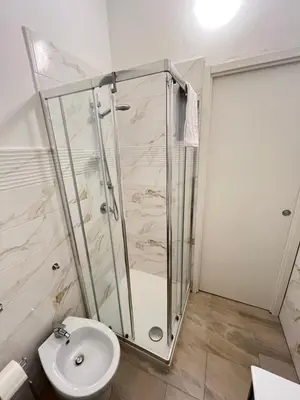 a bathroom with a shower and a toilet at Villareale28 suite in Palermo