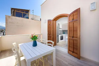 a kitchen and dining room with a white table and chairs at A Casa Di Vale in San Vito lo Capo