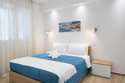 a bed with two pillows on it in a bedroom at S&L Central Apartment in Palermo