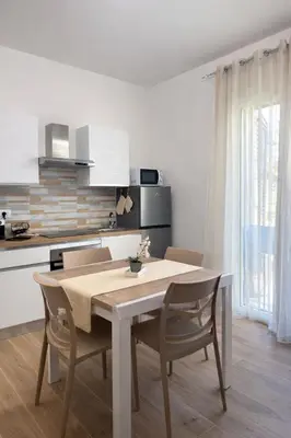 a kitchen with a table and chairs in a room at S&L Central Apartment in Palermo