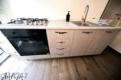 a kitchen with a sink and a stove at Terra Sicula Ballaroom in Palermo