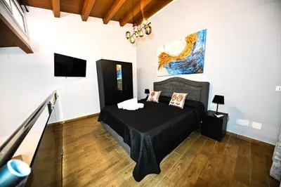 a living room with a table and a staircase at Terra Sicula Ballaroom 1 in Palermo