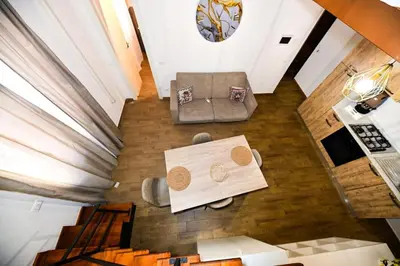 a wooden table with two circles on it on a floor at Terra Sicula Ballaroom 1 in Palermo