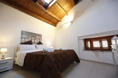 a bedroom with a large bed with two towels on it at Apartment Papyri in Palermo