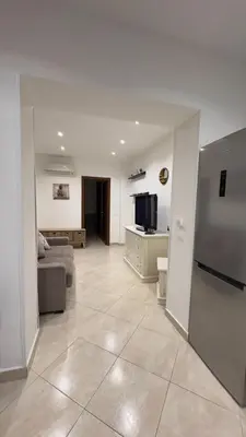 a living room with a couch and a kitchen at Calandreafamily, appartamento 2 camere da letto vicino al centro Palermo in Palermo