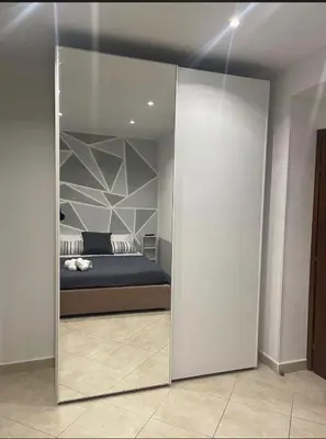 a bedroom with a mirrored door with a bed in it at Calandreafamily, appartamento 2 camere da letto vicino al centro Palermo in Palermo