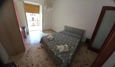 a bedroom with a bed with two towels on it at Framamired in Palermo