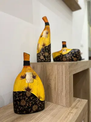 three vases sitting on top of a wooden shelf at Zabaria Home - Appartamenti tra Cefalù e Palermo in Casteldaccia