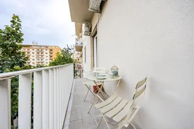 a balcony with a table and chairs on a building at Angelica holiday home in Palermo