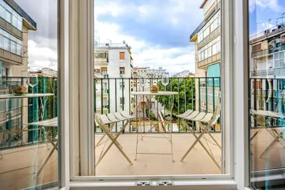 a balcony with two chairs and a table at Angelica holiday home in Palermo
