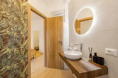 a bathroom with a white sink and a mirror at Angelica holiday home in Palermo
