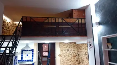 a loft bed in a house with a staircase at casa carmela in Bolognetta