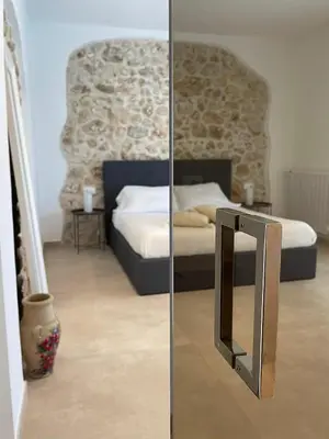 a mirror in front of a bedroom with a bed at Curina Boutique Stay - Luxury Villa in the Sicilian Countryside in Castellammare del Golfo