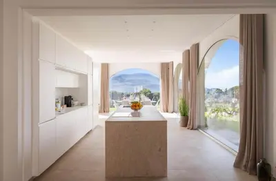 a kitchen with a counter and a large window at Curina Boutique Stay - Luxury Villa in the Sicilian Countryside in Castellammare del Golfo