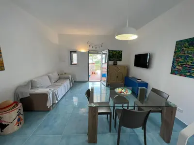 a living room with a table and a couch at Paradiso Isulidda in Macari