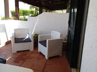 two wicker chairs sitting on a patio at Paradiso Isulidda in Macari