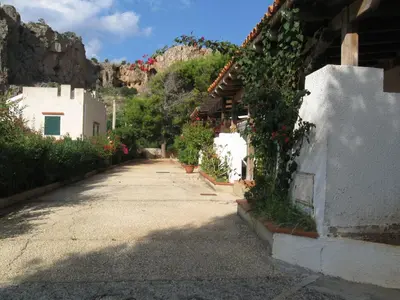 an empty street with flowers on the side of a building at Paradiso Isulidda in Macari