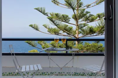 a view of the ocean from the balcony of a house at White and Sea Villa fronte mare a Mondello Addaura in Palermo