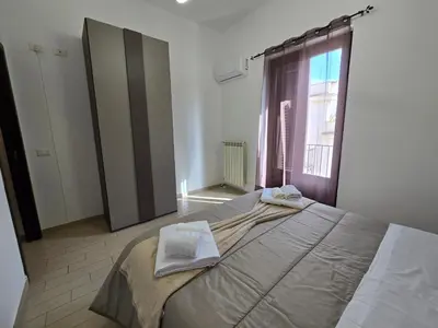 a bedroom with a large bed in a room at Guglie del centro in Palermo