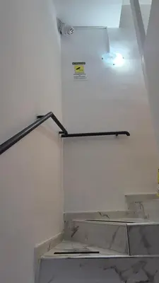 a staircase with a light and a sign on the wall at La Casuzza 3 al mare in Palermo