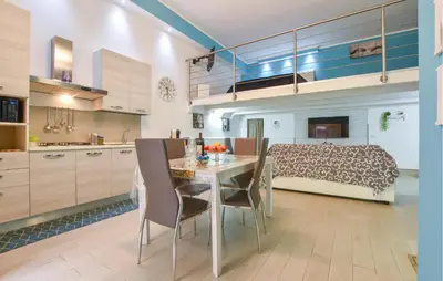 a kitchen and dining room with a table and chairs at Casa Toledo in Partinico