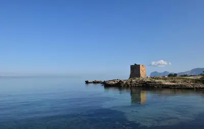 a castle on an island in the middle of the water at Casa Toledo in Partinico