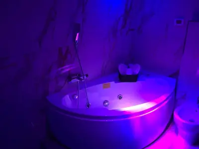 a bathroom with a tub with a purple light at Alba Camere in Palermo