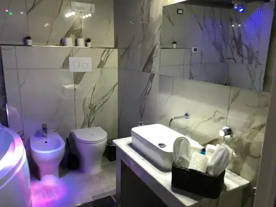 a bathroom with a sink and a toilet at Alba Camere in Palermo