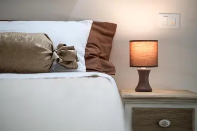 a bedroom with a bed with a lamp on a night stand at Quattro Canti Apartments in Palermo