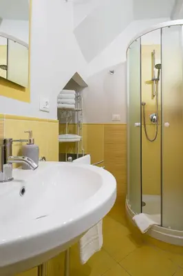 a bathroom with a sink and a shower at Quattro Canti Apartments in Palermo
