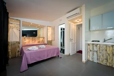 a bedroom with a purple bed in a room at Via Nuova in Castellammare del Golfo