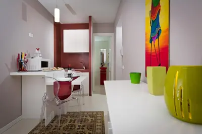 a kitchen with a table and chairs in a room at Via Nuova in Castellammare del Golfo
