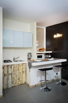 a kitchen with white cabinets and a counter top at Via Nuova in Castellammare del Golfo