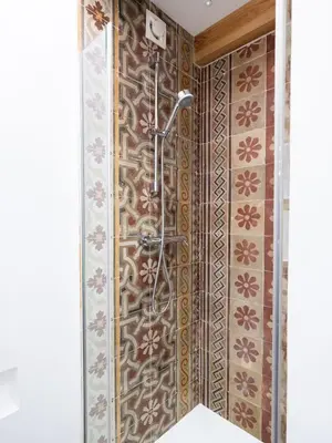 a shower in a bathroom with a tile wall at Via Nuova in Castellammare del Golfo