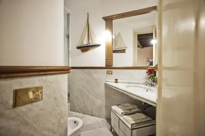 a bathroom with a sink and a toilet and a mirror at Trilocale al Politeama - Zyz in Palermo