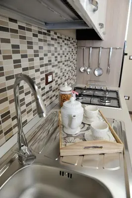a kitchen sink with a tray with tea cups on it at Case Vacanze Terra Sinus in Terrasini