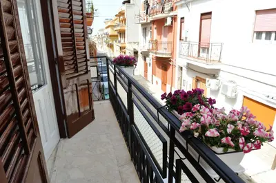 an apartment balcony with flowers on a balcony at Case Vacanze Terra Sinus in Terrasini
