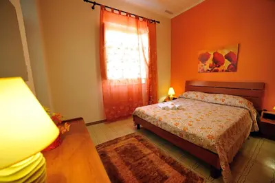 a bedroom with a bed and a window at Case Vacanze Terra Sinus in Terrasini
