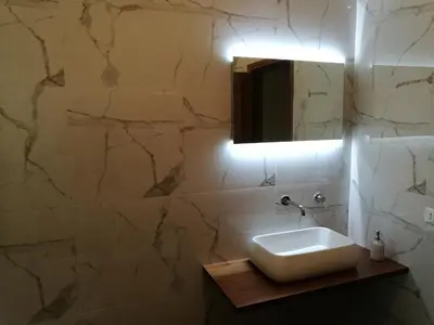 a bathroom with a sink and a mirror at Villa Agave - SeaFront - Pool Kids - BBQ in Santa Flavia