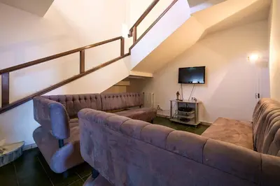 a living room with a couch and a tv at Villa Agave - SeaFront - Pool Kids - BBQ in Santa Flavia