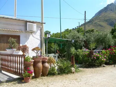 a garden with flowers and plants in front of a house at Casa Vacanza e Camera Fabiola in Castellammare del Golfo