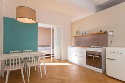 a kitchen with a table and a dining room at Residence Itaca in Castellammare del Golfo