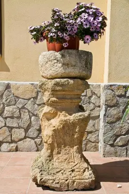 a flower pot sitting on top of a rock at Agriturismo Rajata in Bagheria