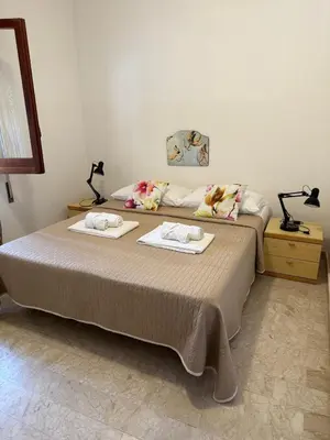 a bedroom with a bed with two towels on it at Casa Vacanza Mare in Castellammare del Golfo